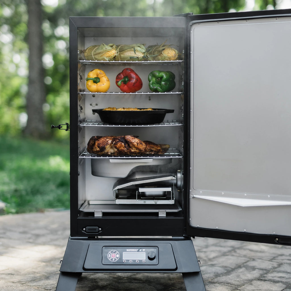 An open 710 WiFi smoker showing 4 racks of food and the removable water pan.