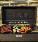 Sausages and vegetables on an open Portable Charcoal BBQ and Smoker