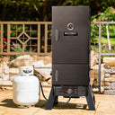 Smoking with gas on the patio using the Masterbuilt Pro Series Dual Fuel Smoker. Small gas bottle sits to the left of the smoker.