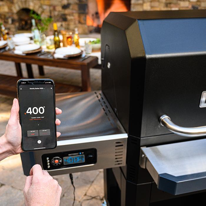 Using the Masterbuilt App on a smartphone to monitor cooking temperature