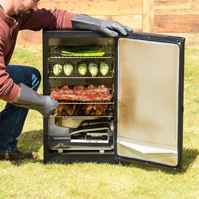 Digital electric smoker with door open to show smoking ribs, chickens and vegetables on 4 racks